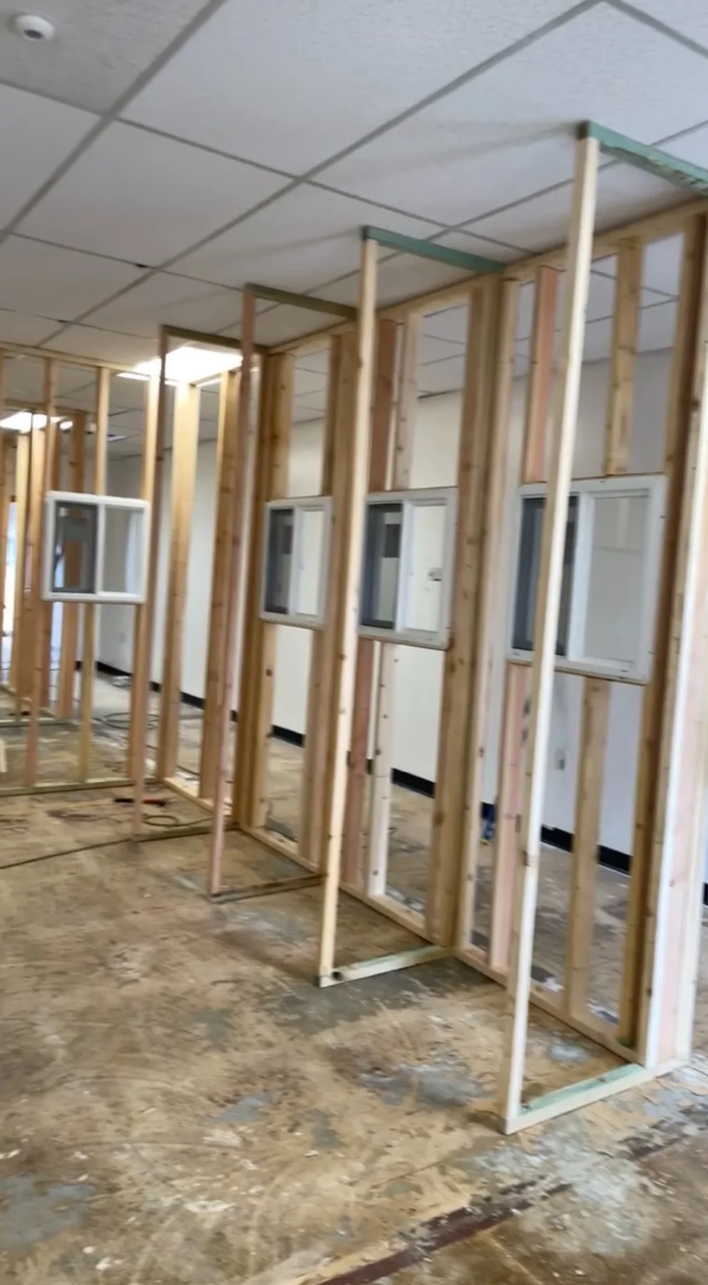 Interior stud-wall framing used to reconfigure a room layout and create framed openings